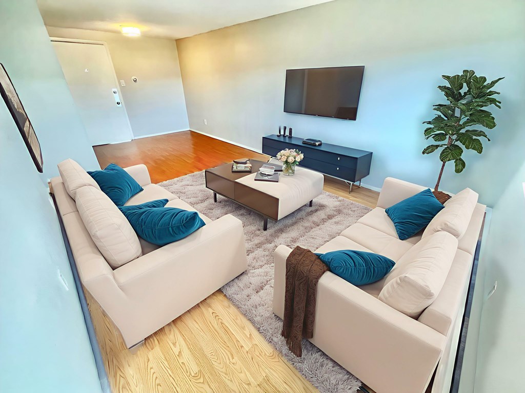 A two-story apartment building with a front yard and a mailbox.