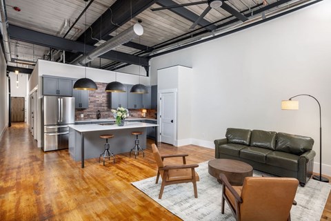 A modern kitchen with a bar area and a couch.