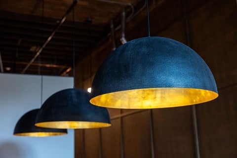 Two black lampshades hanging from the ceiling.