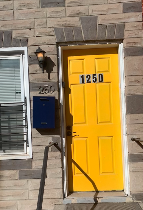 A yellow door with the number 1250 on it.