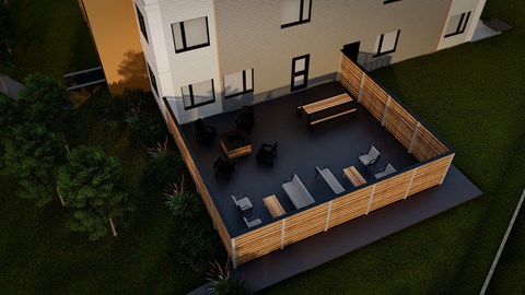 A modern house with a deck and outdoor furniture.