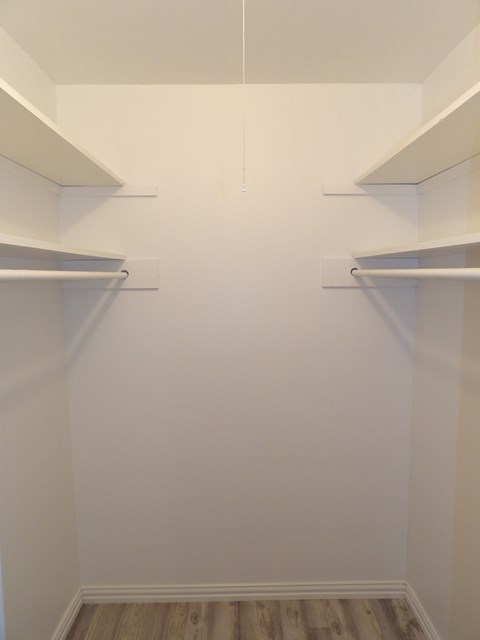 Empty white shelves in a room.