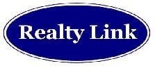 A blue oval sign with the words "Realty Link" written in white.