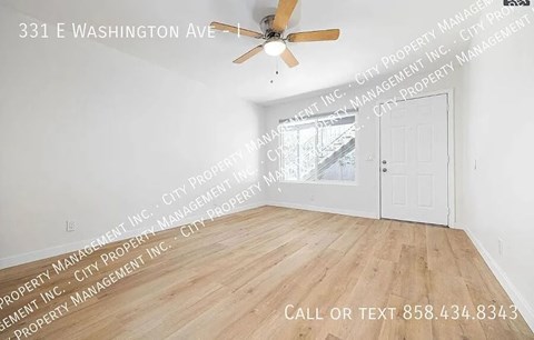 A room with a ceiling fan and wooden flooring is on the market at 331 E Washington Ave.