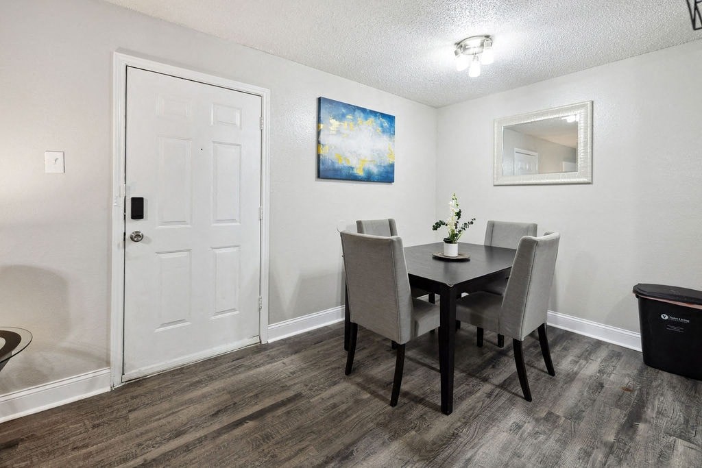 A dining room with a table and chairs.