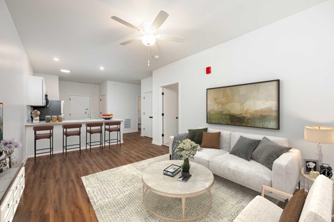A living room with a white couch, a coffee table, and a painting on the wall.