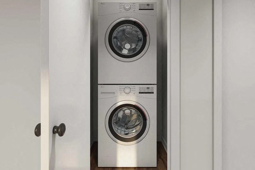 A washing machine is placed in a cabinet.