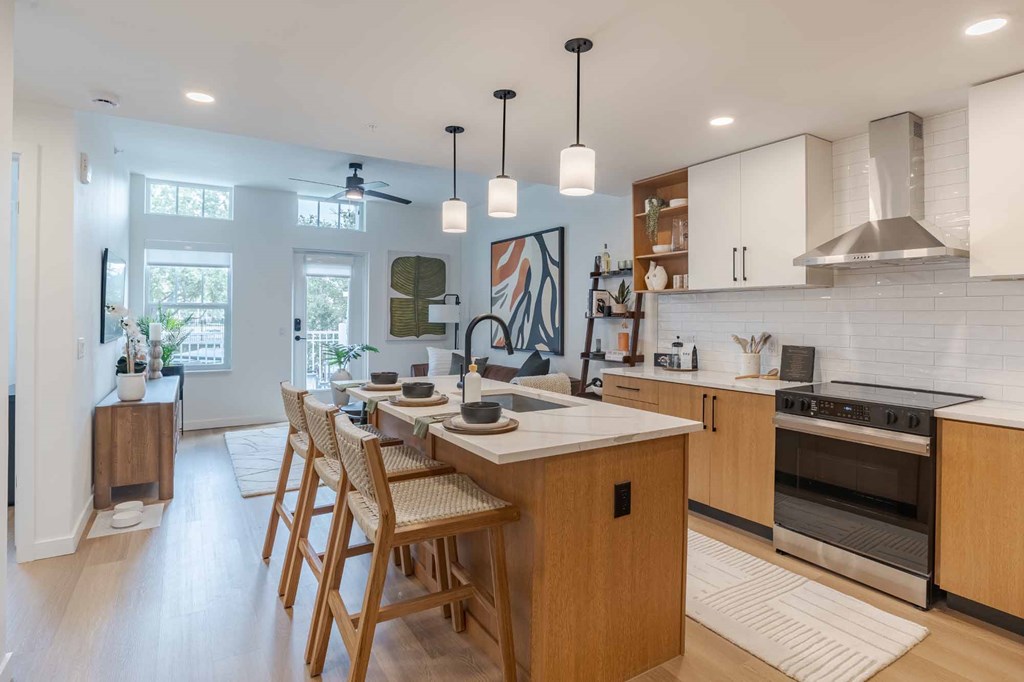 A modern kitchen with a dining table and chairs.