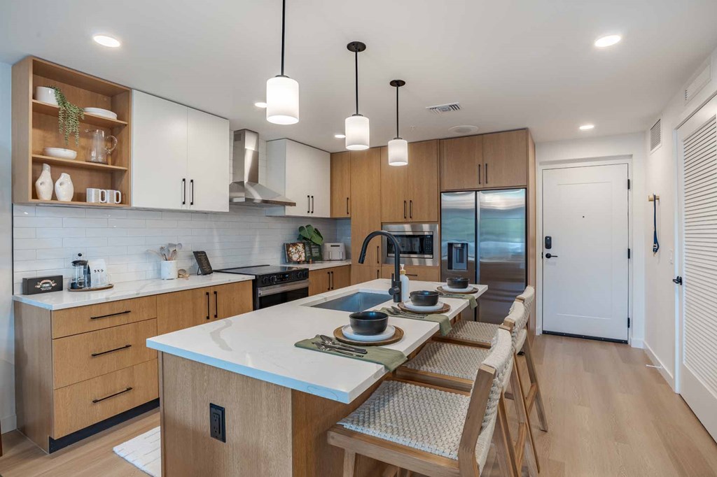 A modern kitchen with wooden cabinets and a white countertop.