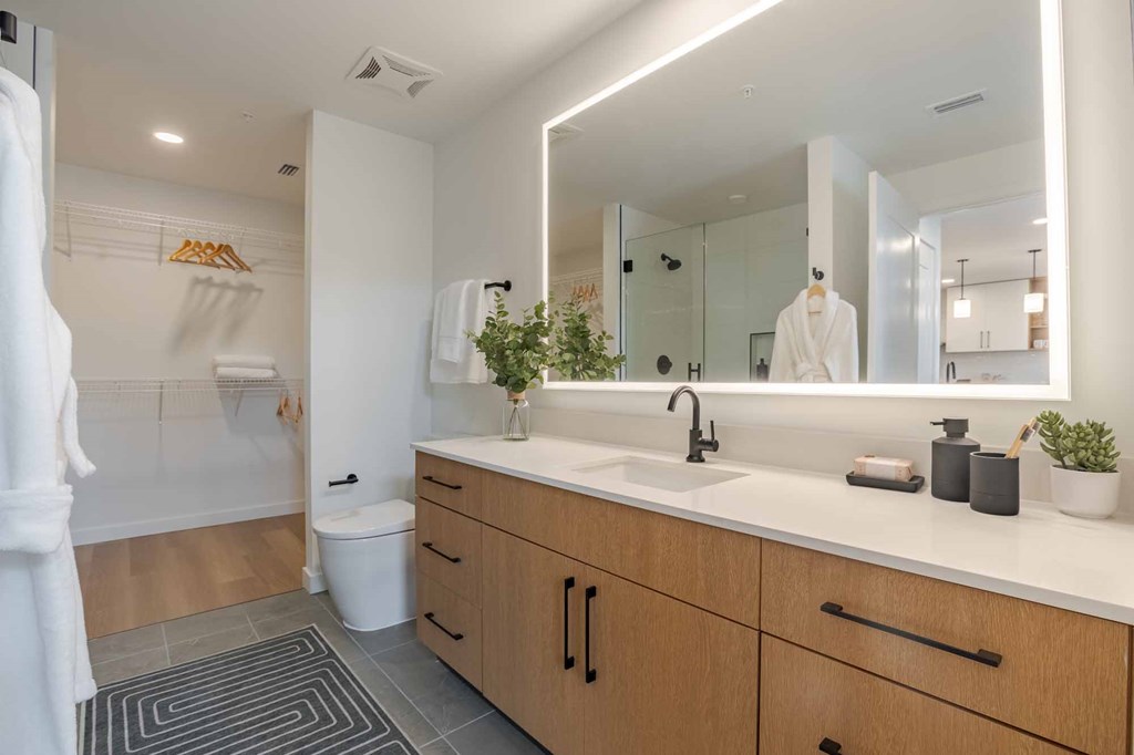 A bathroom with a white towel hanging on the door.