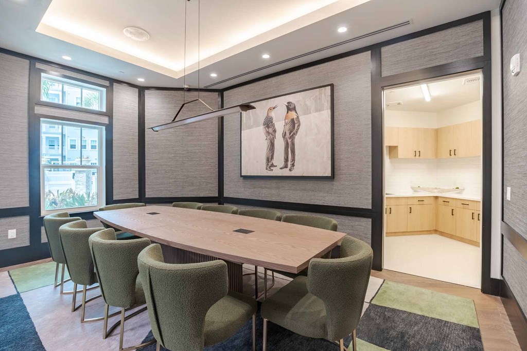 A conference room with a long table and chairs.