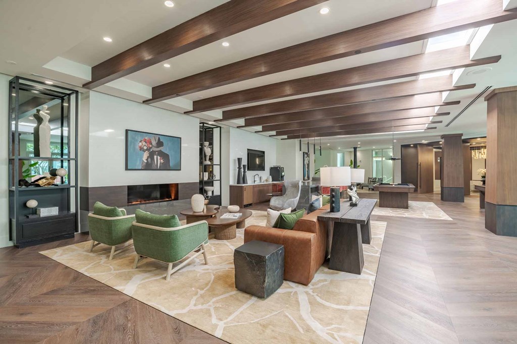 A modern living room with a fireplace and a large rug.