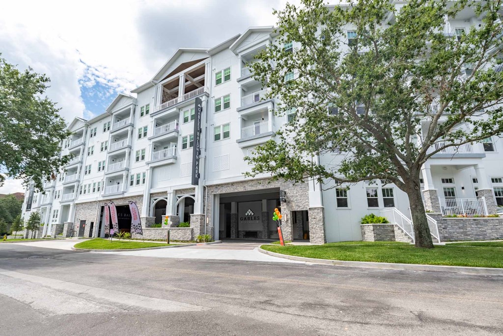 A large white building with a black door and windows.