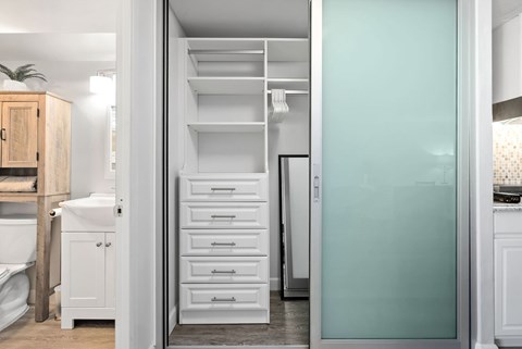 A kitchen with a white cabinet and a white fridge.