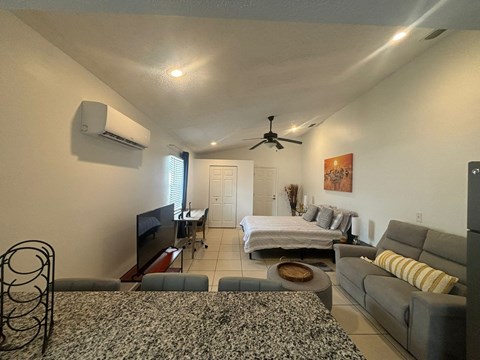 A living room with a grey couch and a television.
