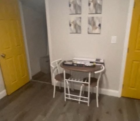 A small table with two chairs in a room.
