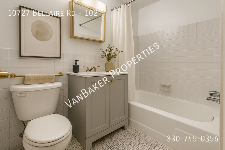A bathroom with a toilet, sink, and bathtub.