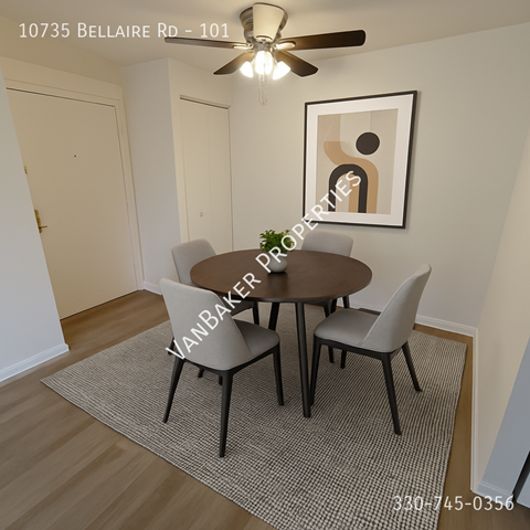A dining room with a table and chairs and a ceiling fan.