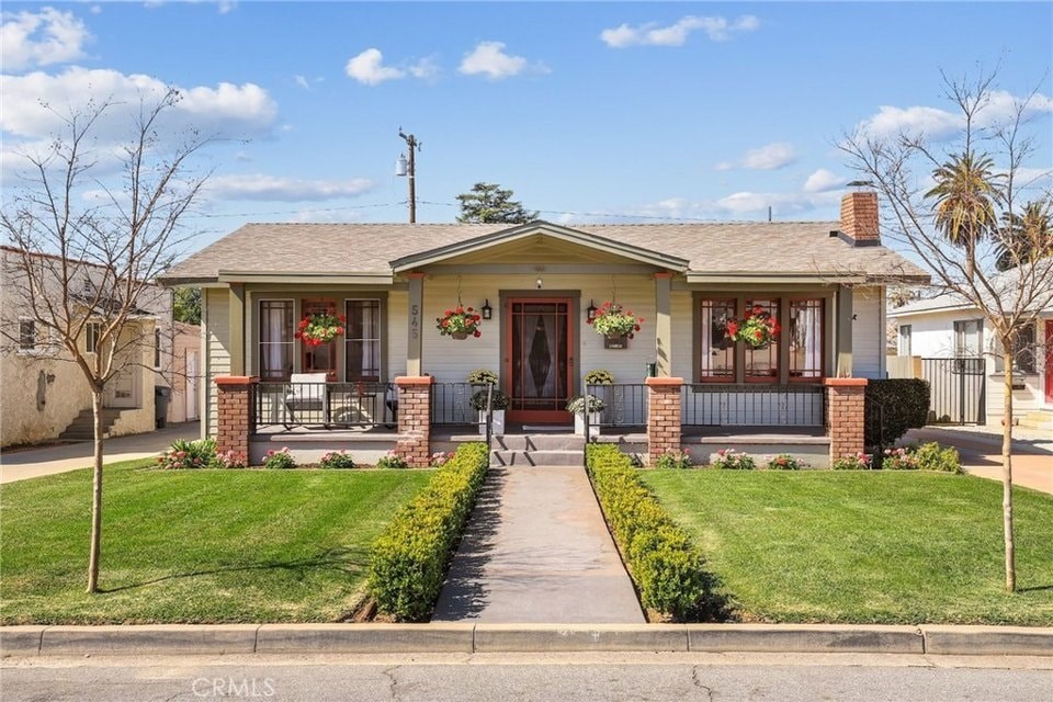 A house with a front yard and a porch.