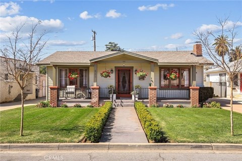 A house with a front yard and a porch.
