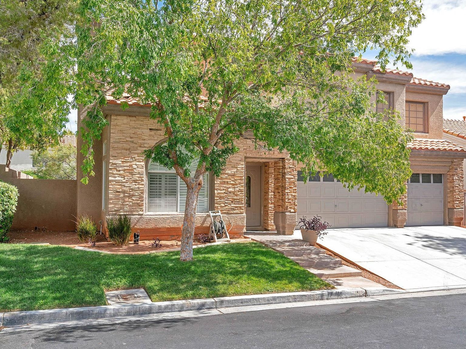 A house with a tree in front of it.
