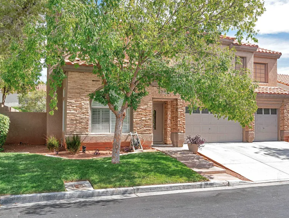 A house with a tree in front of it.