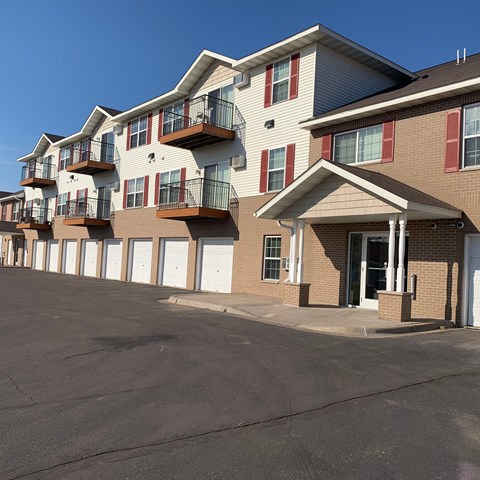 A row of townhouses with garages and balconies.
