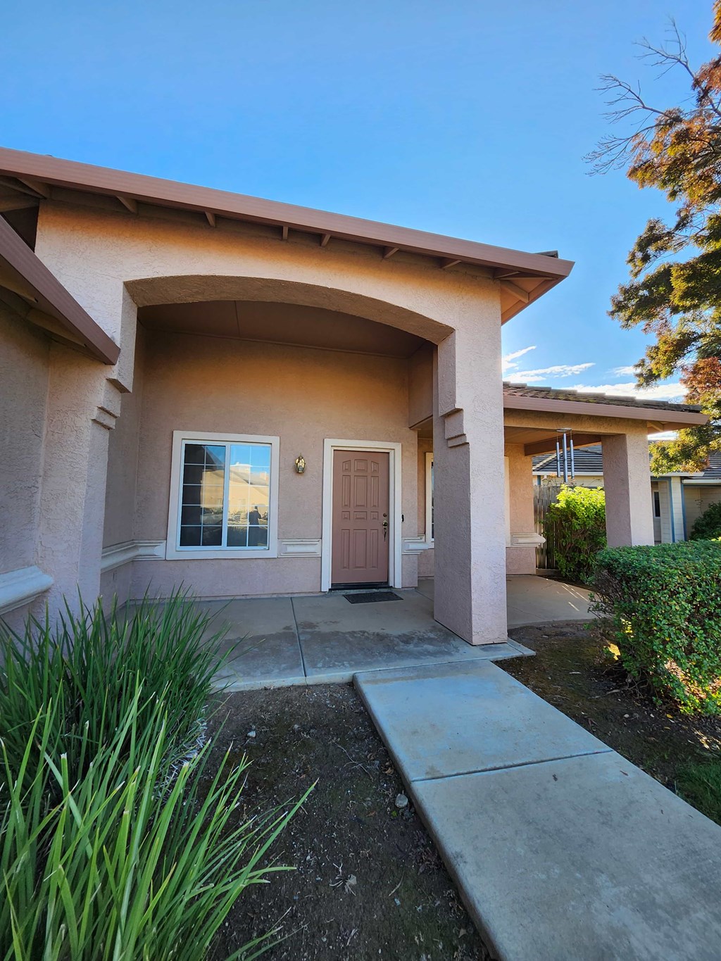 A house with a brown door and a brown roof.