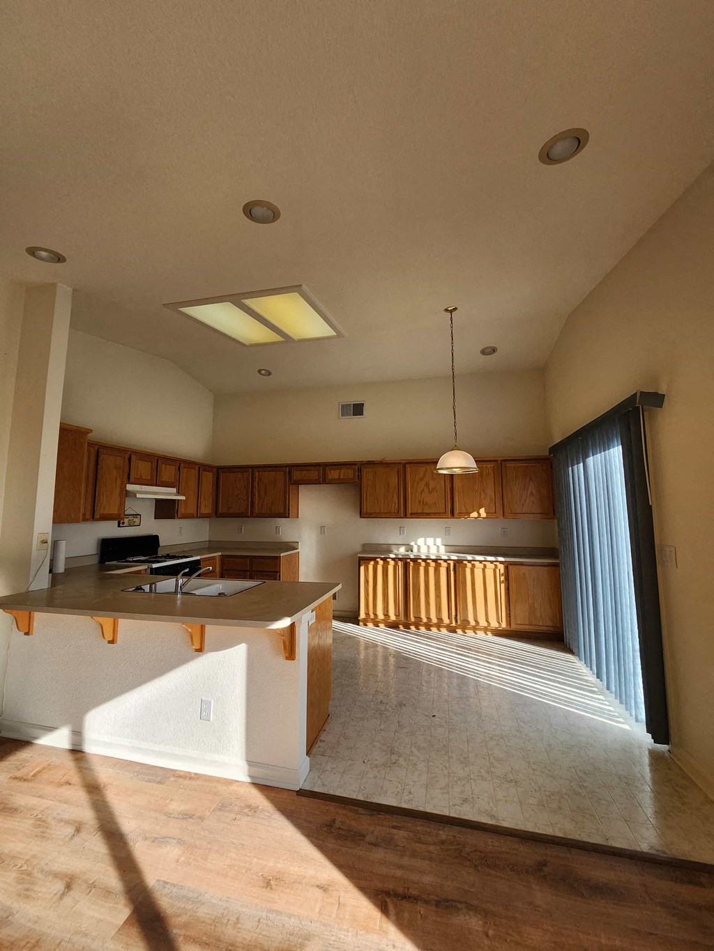 A kitchen with wooden cabinets and a countertop is shown.