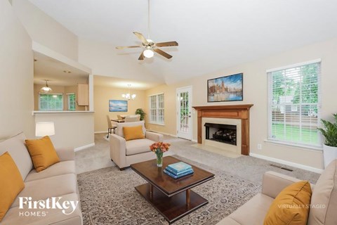 A living room with a fireplace and a painting on the wall.