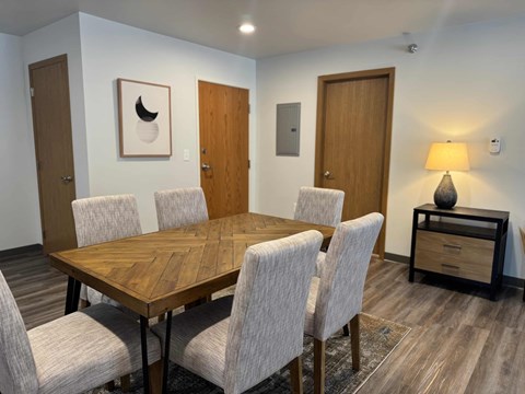 A conference room with a wooden table and chairs.