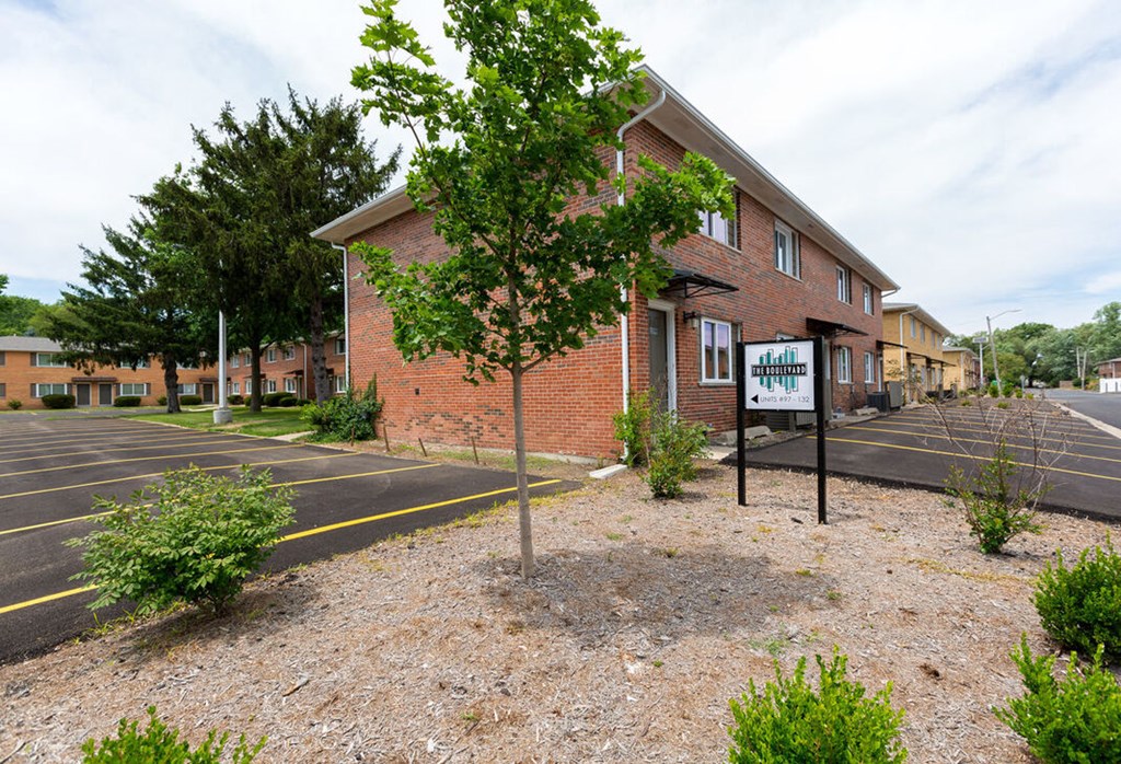 A building with a sign that says "The Shore" in front of it.
