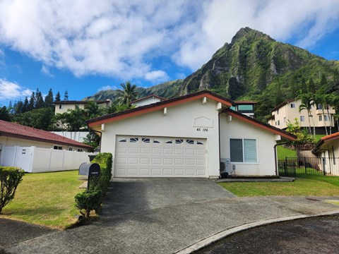 A house with a mountain in the background.