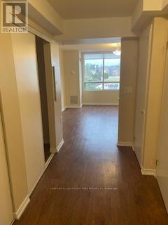 A long hallway with a Realty logo on the bottom left.