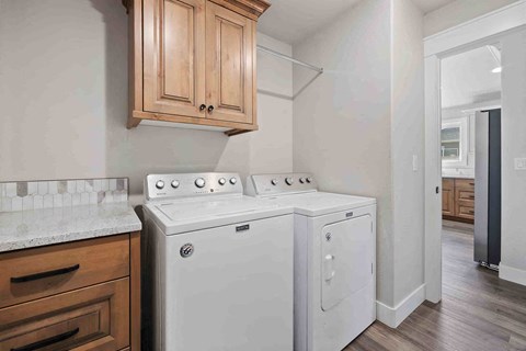 A white stove and oven in a kitchen with wooden cabinets.