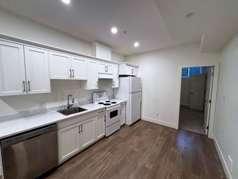 A kitchen with white cabinets and stainless steel appliances.