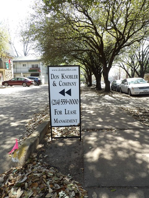 A sign for Don Knobler & Company offering lease management services.