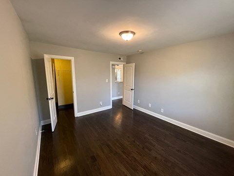A room with wooden floors and white walls.