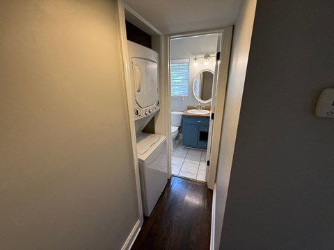 A small bathroom with a toilet, sink, and mirror.