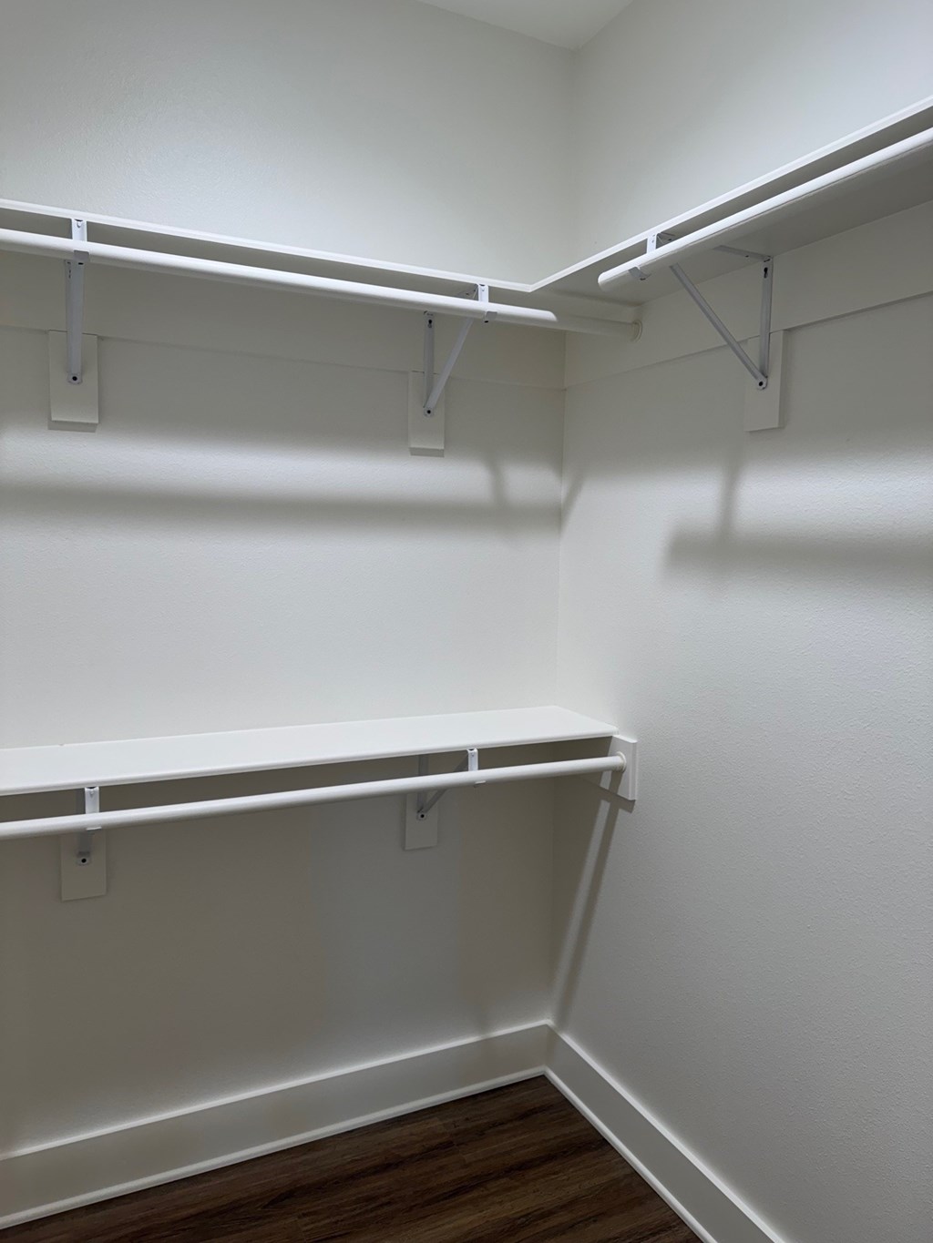 Empty white shelves in a room.