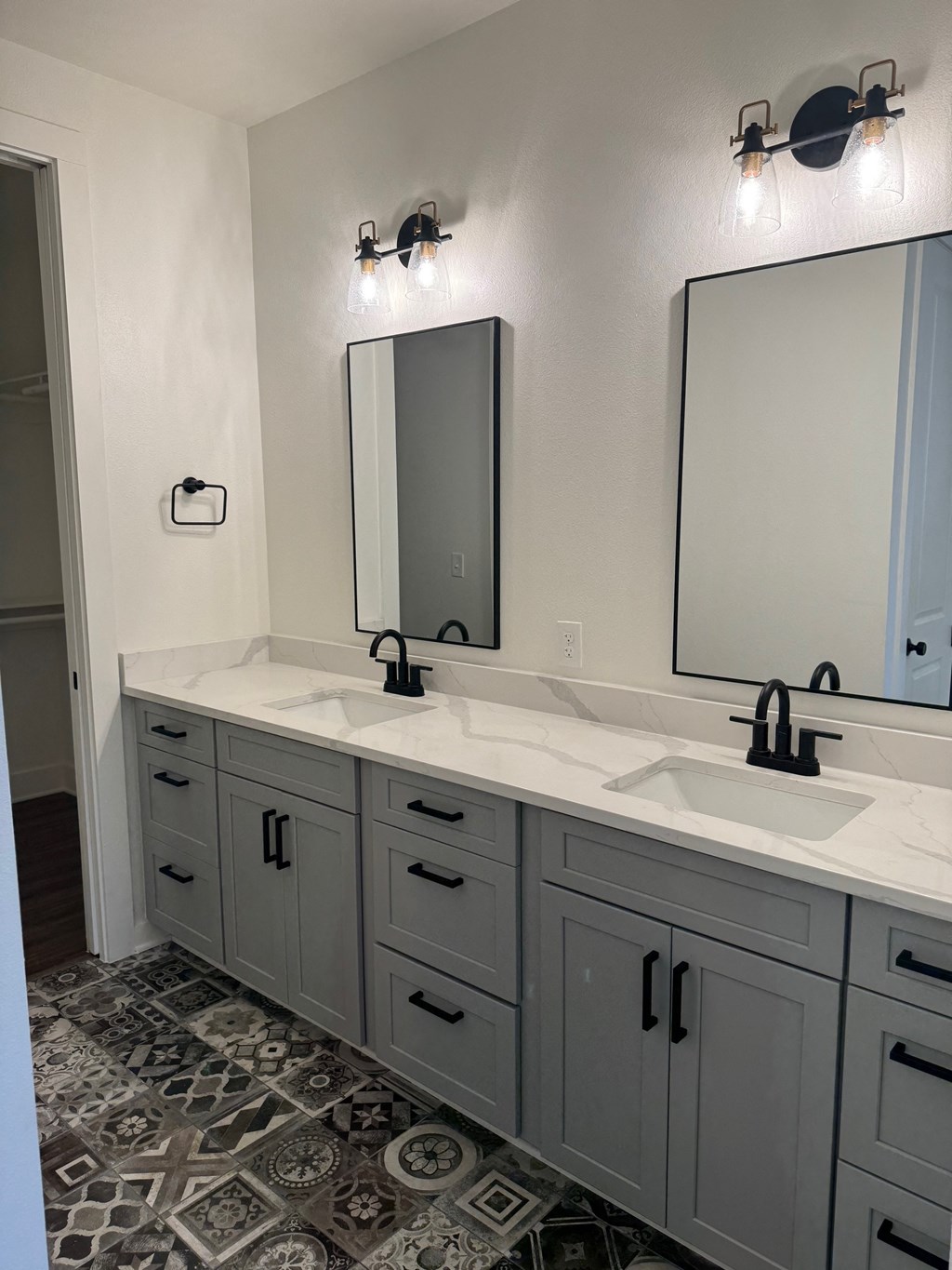 A bathroom with two sinks and a large mirror.