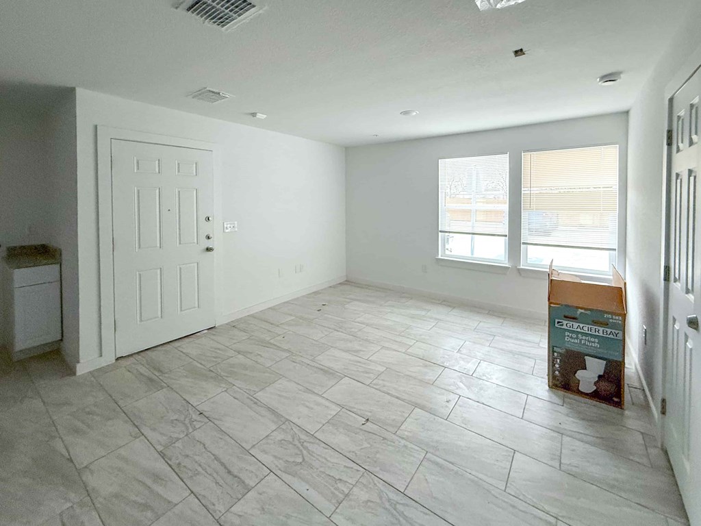 A room with a box of tiles on the floor.