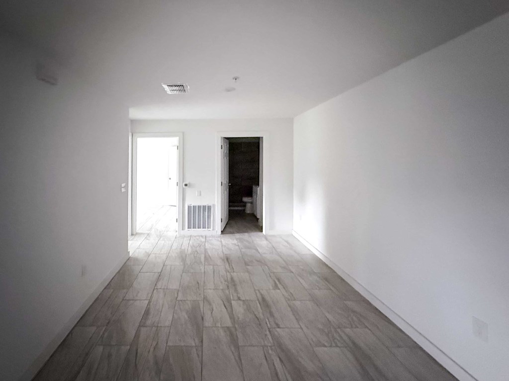 A long hallway with a door at the end.