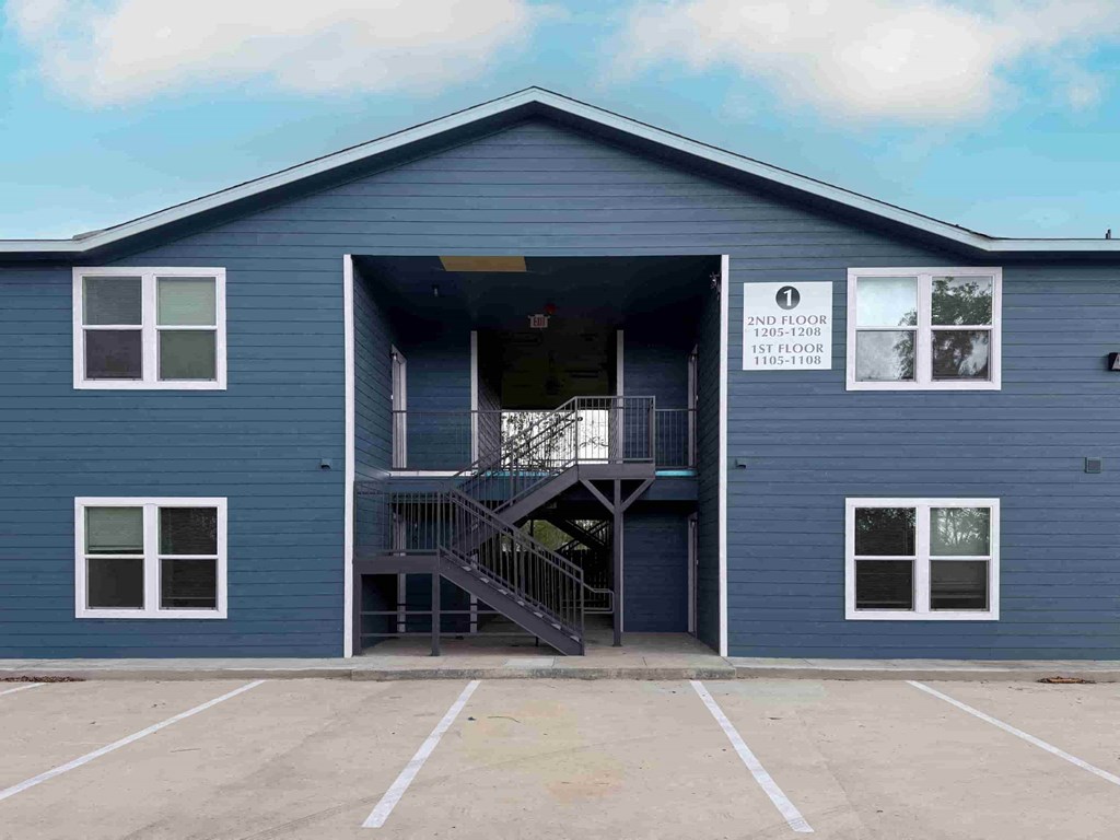 A blue building with a sign on the front that says "2ND FLOOR 1205-2000 1105-1100".