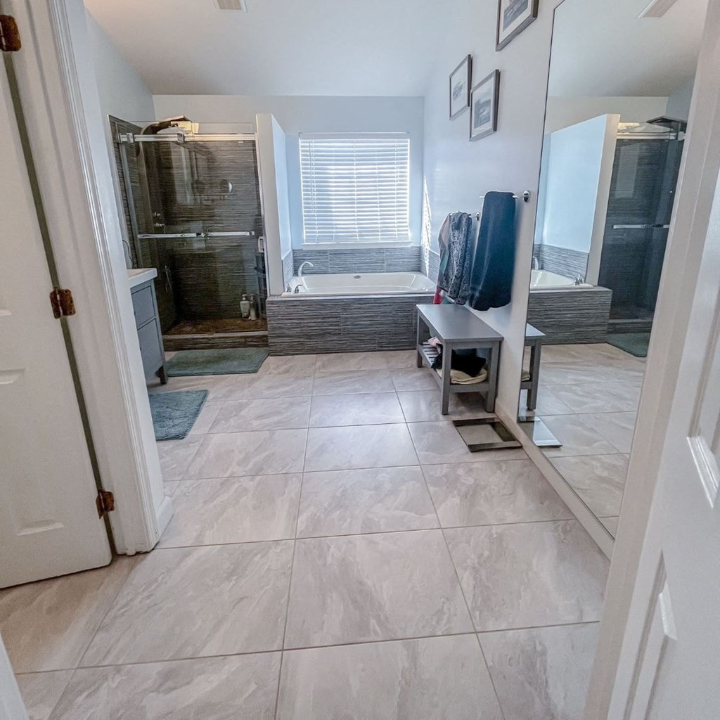 A bathroom with a walk-in shower and a bathtub.
