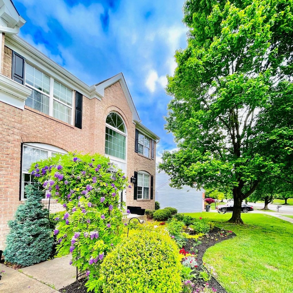 A house with a well-maintained garden in front.