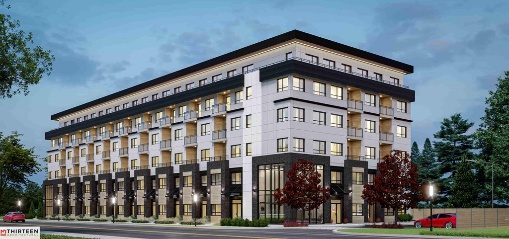 A modern multi-story building with balconies and large windows.