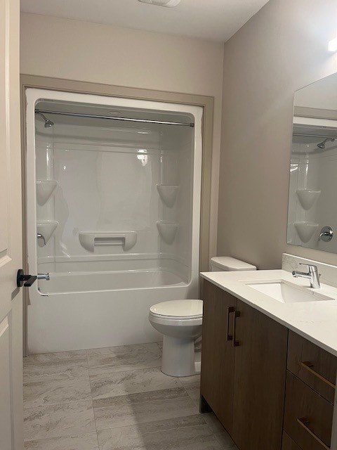 A bathroom with a toilet, sink, and shower.