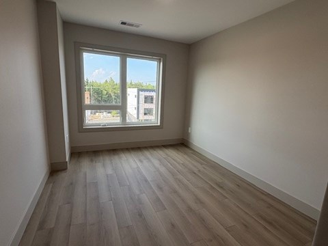 A room with a window overlooking a cityscape.