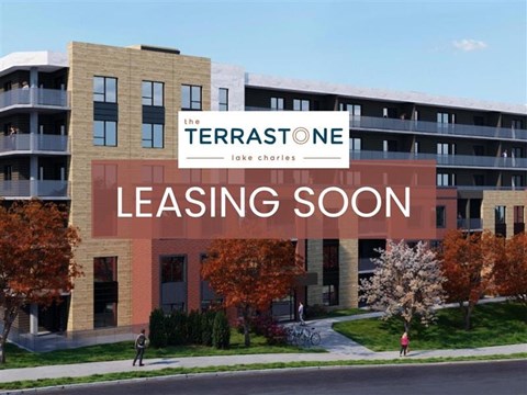 A building with a sign that says "The TerraStone leasing soon".